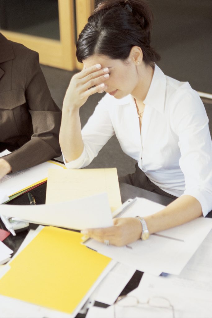 businesswoman-looking-through-files-1711171-683x1024